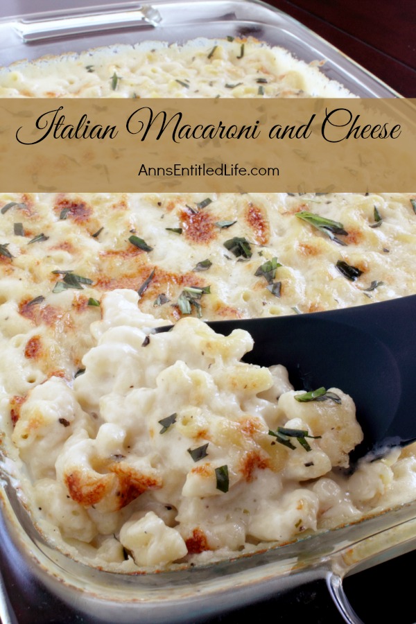 A pan of baked Italian style macaroni and cheese, a serving spoon is lifting out a portion directly from  the pan