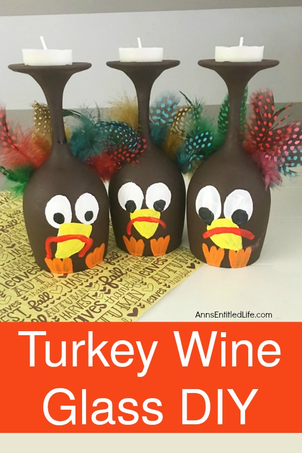 Three wine glasses in a row that are painted to look like turkeys sitting on top of a Thanksgiving-themed paper.