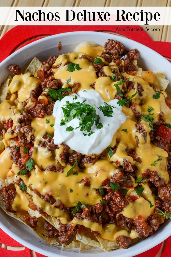 front view of a bowl of tortillas topped with ground beef, cheese, sour cream