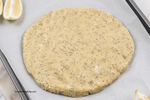 Lemon Poppy Seed Scones Recipe with Glaze. This lemon poppy seed scones recipe features a delicious lemon glaze. The result is moist scones bursting with poppy seeds and freshly grated lemon zest. This lemon-flavored scones recipe goes well with afternoon tea or morning coffee.