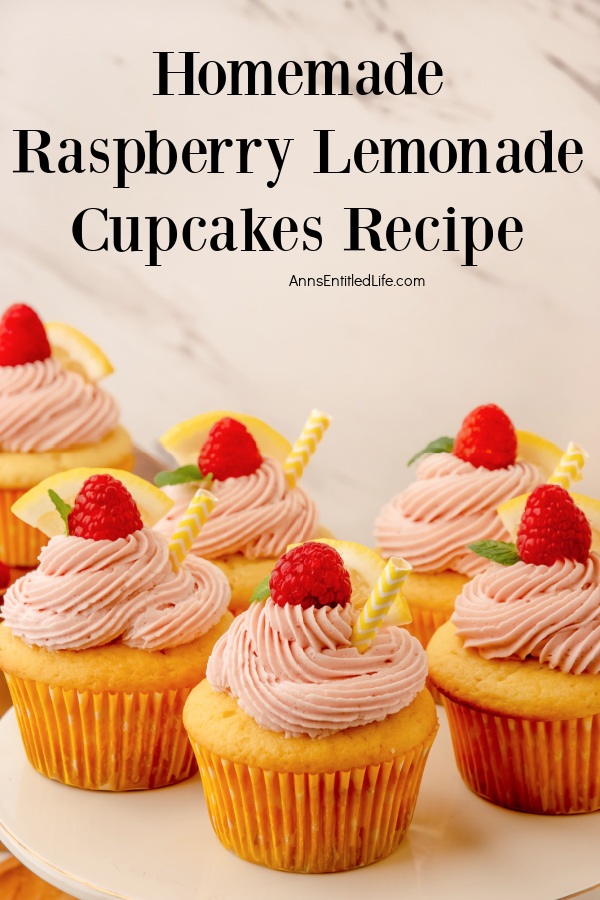 side view of 6 homemade raspberry lemonade cupcakes on a white plate