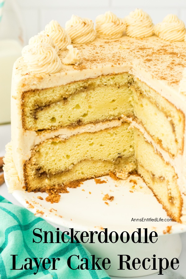 The inside view of a Snickerdoodle cake that is set on a white cake stand. Two pieces of cake were removed to show the inside.