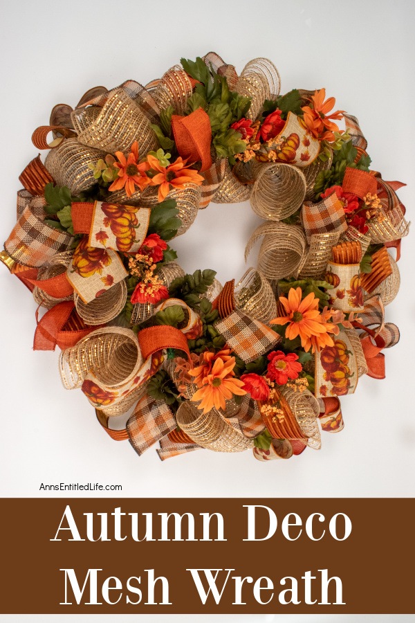 Autumn deco mesh wreath hanging against a wall