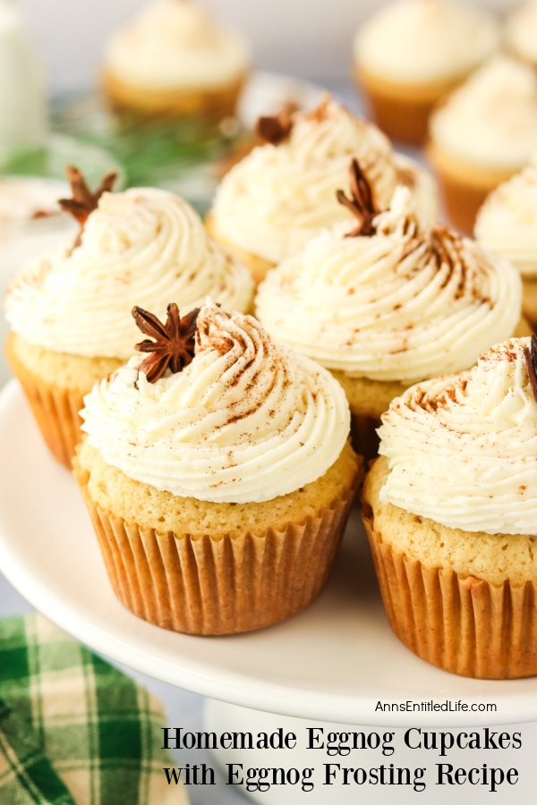 Close-up of eggnog cupcakes on a white cake stand.