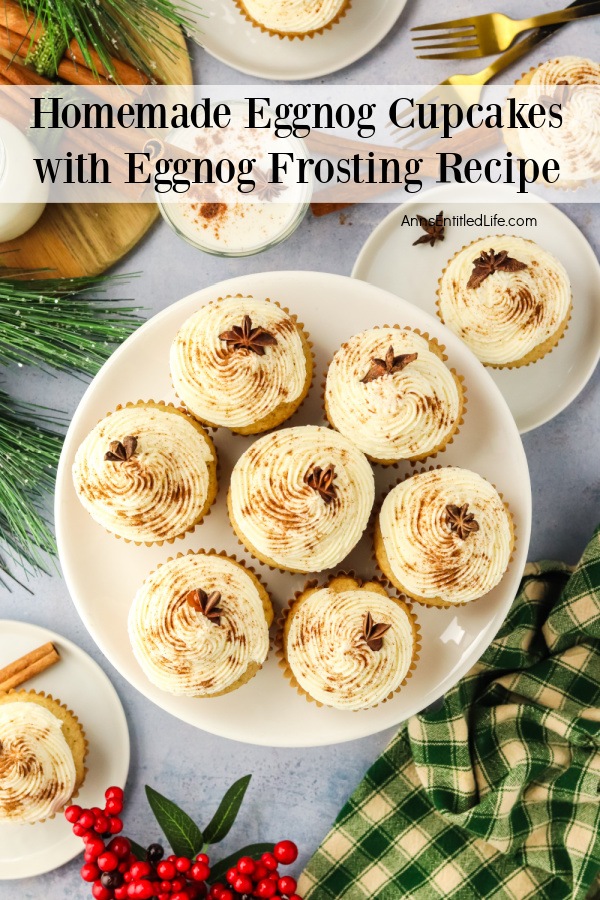 Overhead vuew of eggnog cupcakes on a white cake stand. There are individual cupcakes on white plates above and below the cake stand.