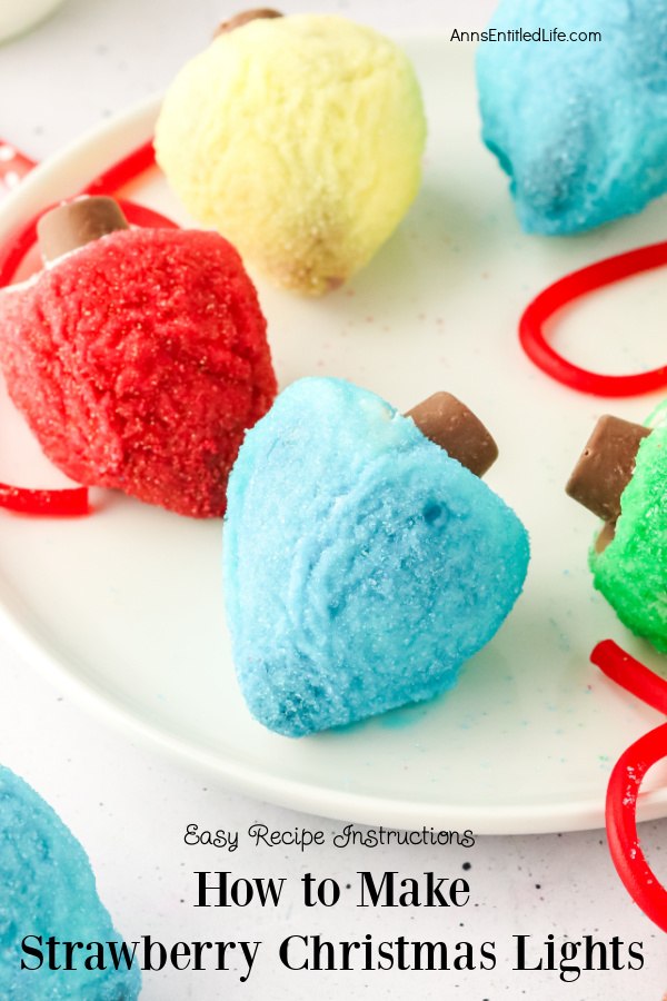 close-up of strawberries on a white plate which are decorated with chocolate and colored sugars to look like vintage Christmas lights