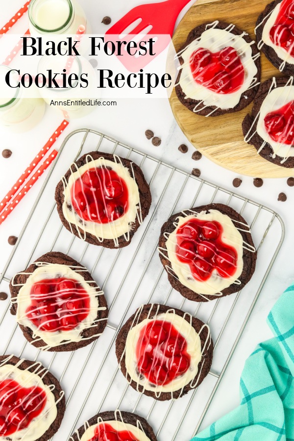 Black forest cookies on a wire rack, several cookies on a wooden board in the upper right