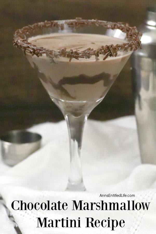 Side view of a chocolate marshmallow martini on a white cloth