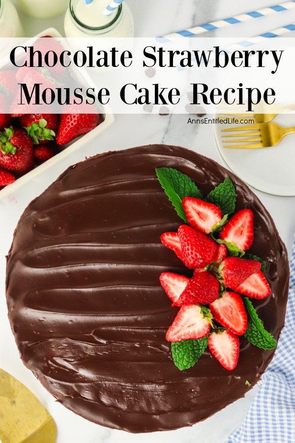 Overhead view of a Homemade Chocolate Strawberry Mousse Cake. There is a pint of fresh strawberries in the upper left.