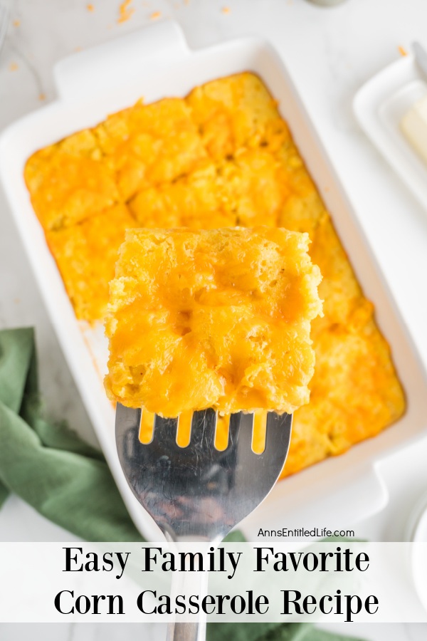 Overhead view of a corn casserole in a white dish with a piece being lifted out