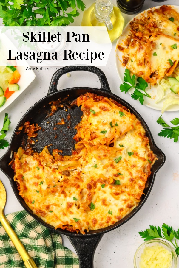 Overhead view of a pan of skillet lasagna, a serving is on a white plate in the upper right, a salad is to the left.